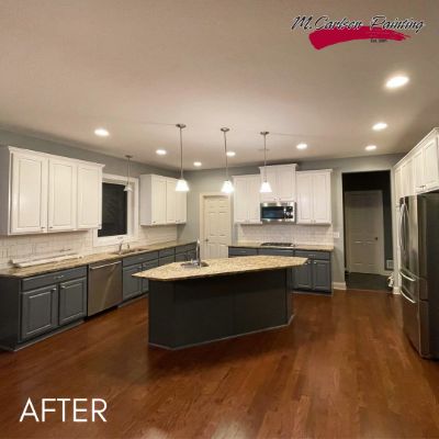 Plymouth kitchen after cabinet refinishing, white upper and charcoal lower cabinets around a granite island