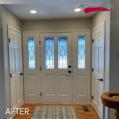 Entrance hall after painting, a white front door with leaded glass sidelights