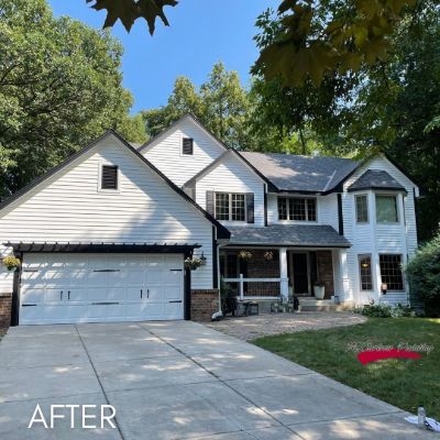 Minnetonka house after exterior painting, white siding with black shutters and a black roof