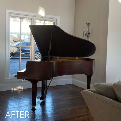 Grand piano after refinishing, standing in a living room