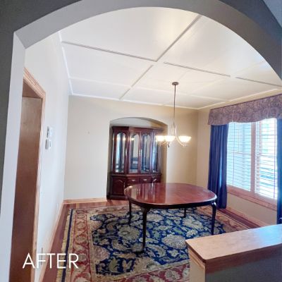 Dining room after painting, cream walls below a coffered ceiling