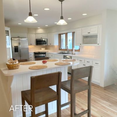 Savage kitchen after cabinet refinishing, white cabinets and a peninsula breakfast bar
