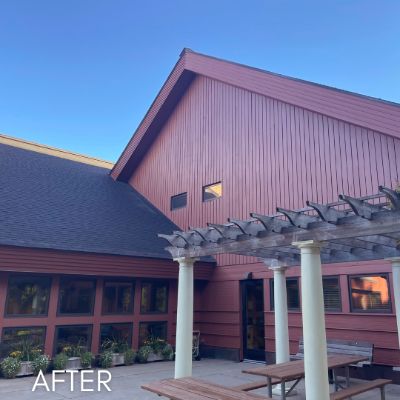 The same Excelsior building after staining, the siding in a deep barn red