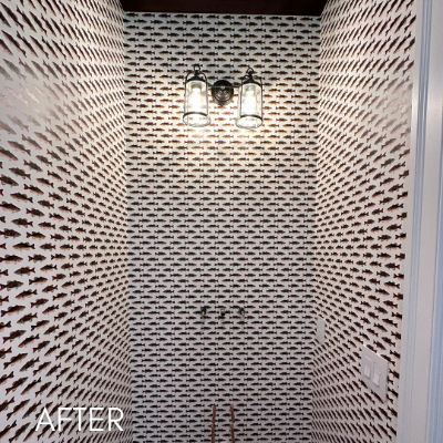 Powder room papered in a dense black and white pattern