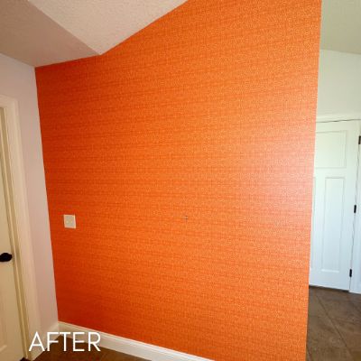 Wall hung with bright orange textured wallcovering