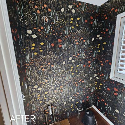 Powder room papered in a dark wildflower print