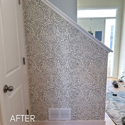 Stairwell papered in a gray medallion print