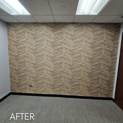 Office wall hung with a pale herringbone wallcovering