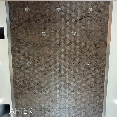 Wall hung with a textured geometric wallcovering in soft gold