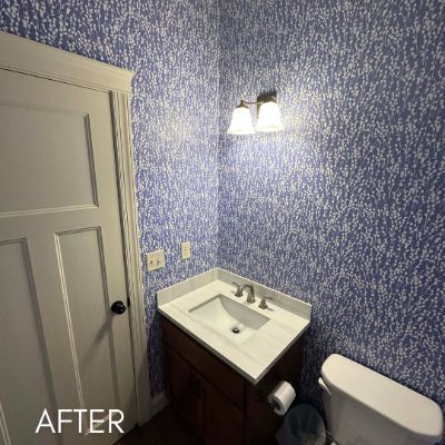 Powder room papered in a dense blue and white print