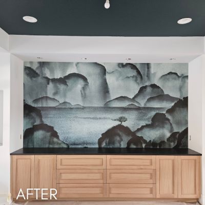 Ink wash landscape mural above a wood credenza