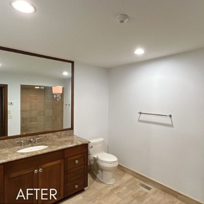 Bathroom after painting, white walls above a granite vanity