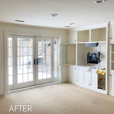 Built-in cabinetry and shelving enameled cream beside french doors