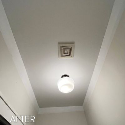Sloped stairwell ceiling after painting, in soft white