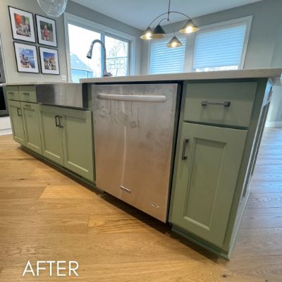 Kitchen island refinished in olive green around a stainless dishwasher