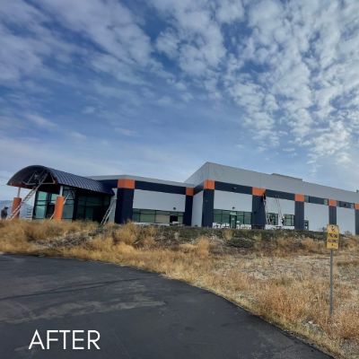 Long commercial building in navy and white with orange pilasters