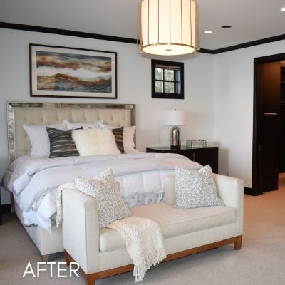 Bedroom after painting, soft white walls above a tufted headboard