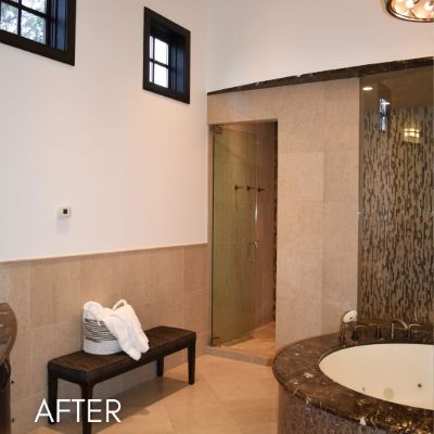 Bathroom after painting, cream walls above a tiled dado and corner tub