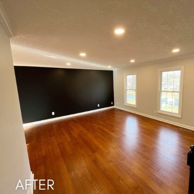 Living room after painting, with a full-height black accent wall