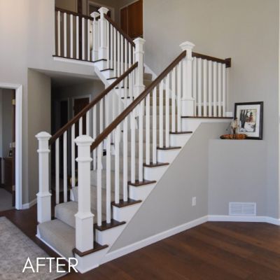 Staircase after painting, white balusters and newel posts against gray walls