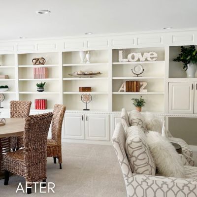Built-in shelving and cabinetry enameled white along a dining room wall