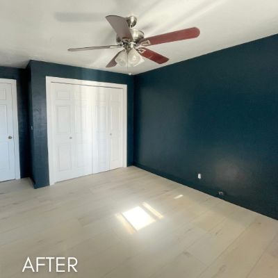 Bedroom after painting, with a deep teal accent wall