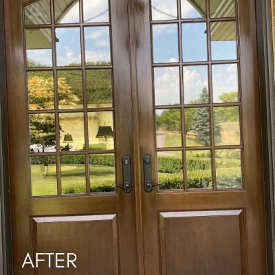 Wood french doors refinished, looking out over a lawn