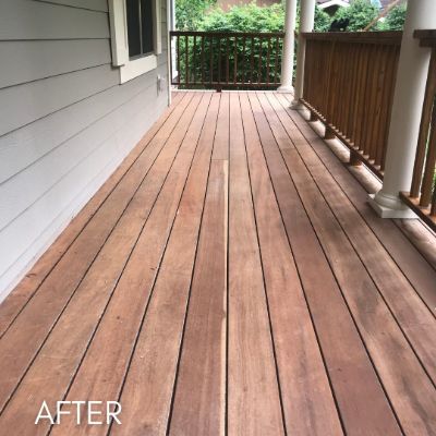 Deck after staining, the boards finished in a warm red brown