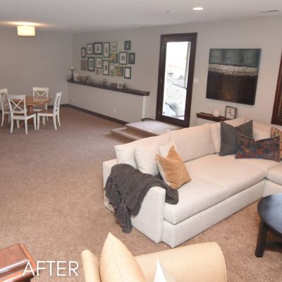 Living room after painting, warm white walls behind a sectional