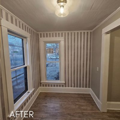 Room papered in a broad taupe and cream stripe