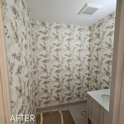 Powder room papered in a pale botanical trailing print