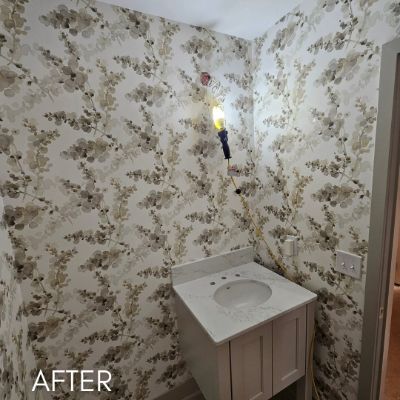 Powder room papered in a pale botanical print above a stone vanity