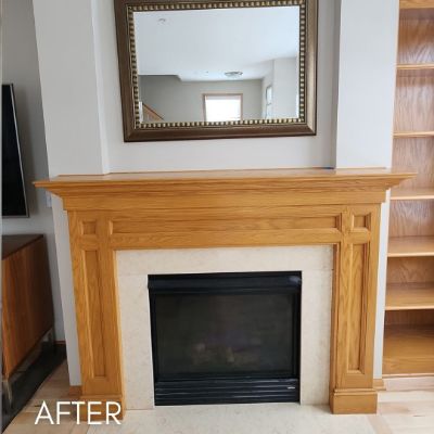 Oak fireplace mantel and surround beside built-in shelving