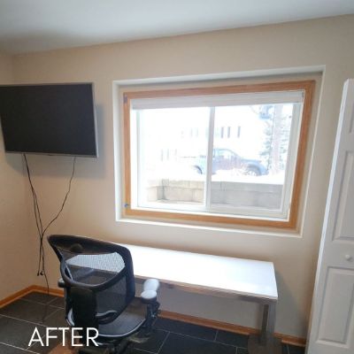 Office after painting, warm beige walls around a wood-framed window