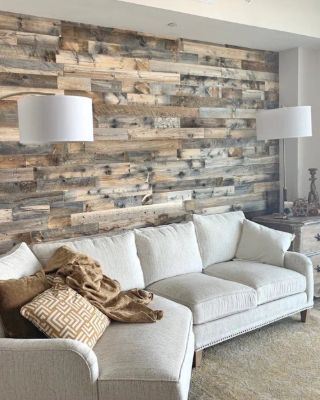 Living room with a reclaimed wood plank accent wall behind a cream sectional sofa