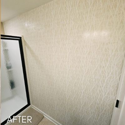 Wall hung with a cream wallcovering in a fine linear pattern