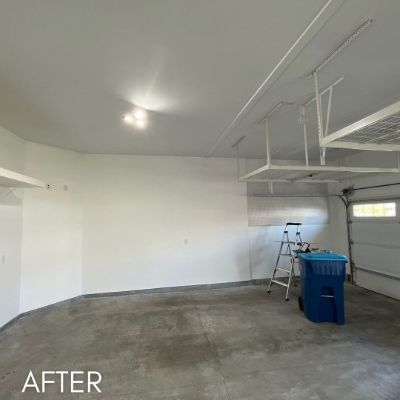 Garage interior after painting, white walls and ceiling above a concrete floor