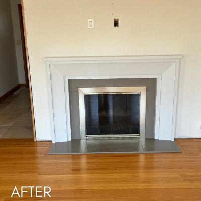 Fireplace surround and mantel enameled white against a cream wall