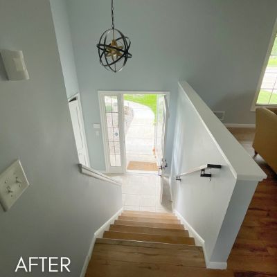 Split entry after painting, white walls and stair rail above wood treads