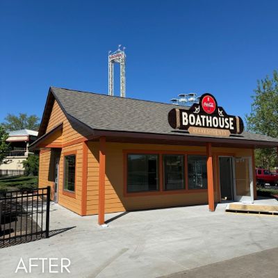 Boathouse restaurant exterior in orange cedar siding under a dark roof