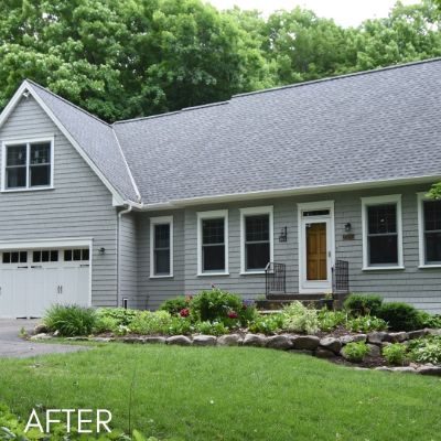 Single-story house in pale gray siding with white trim and an attached garage