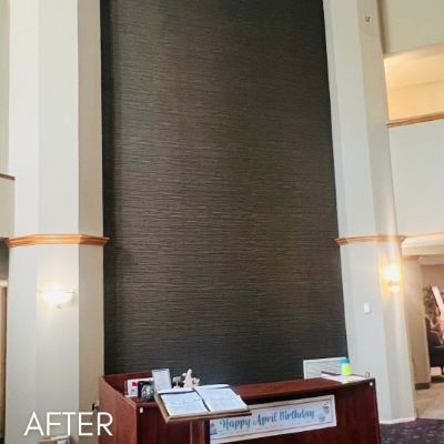 Function room wall in dark grasscloth wallcovering above a wood dado rail