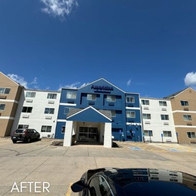 Hotel exterior after painting, in blue, white and tan