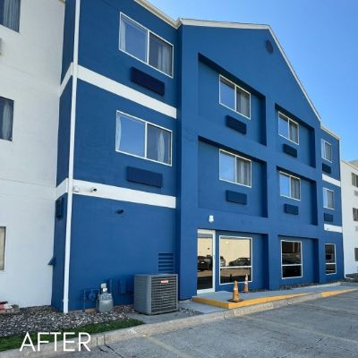 Hotel wing painted bright blue with white banding between floors