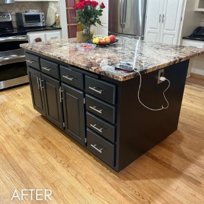 Kitchen island refinished in near-black under a granite top