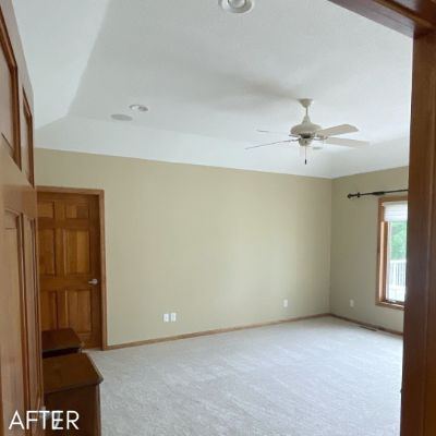 Empty living room after painting, cream walls beside stained oak trim