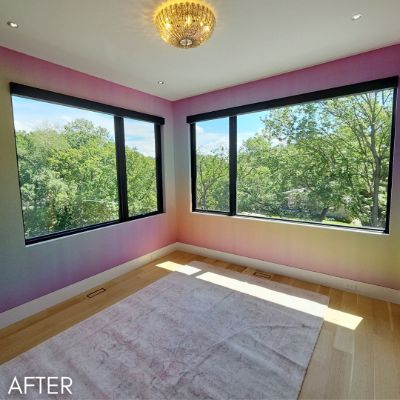 Room painted in a pink and gold gradient between two windows