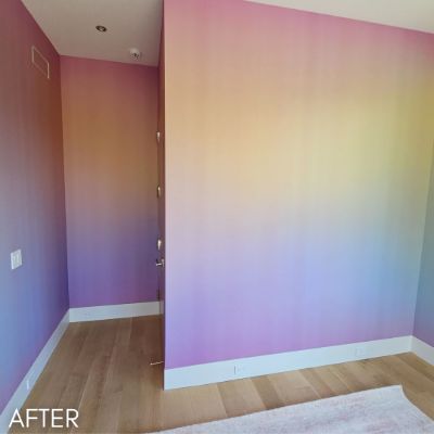 Corner of a room painted in a rainbow gradient, pink to blue
