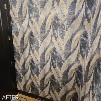 Wall hung with a herringbone wallcovering in gold and gray