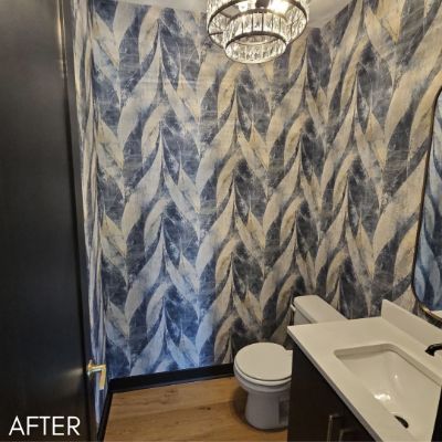 Powder room papered in a blue and gold chevron print